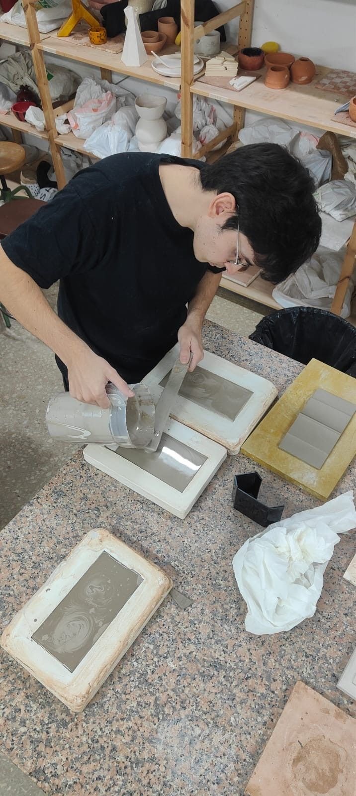 Alberto removing a piece from its mould in the ceramics workshop