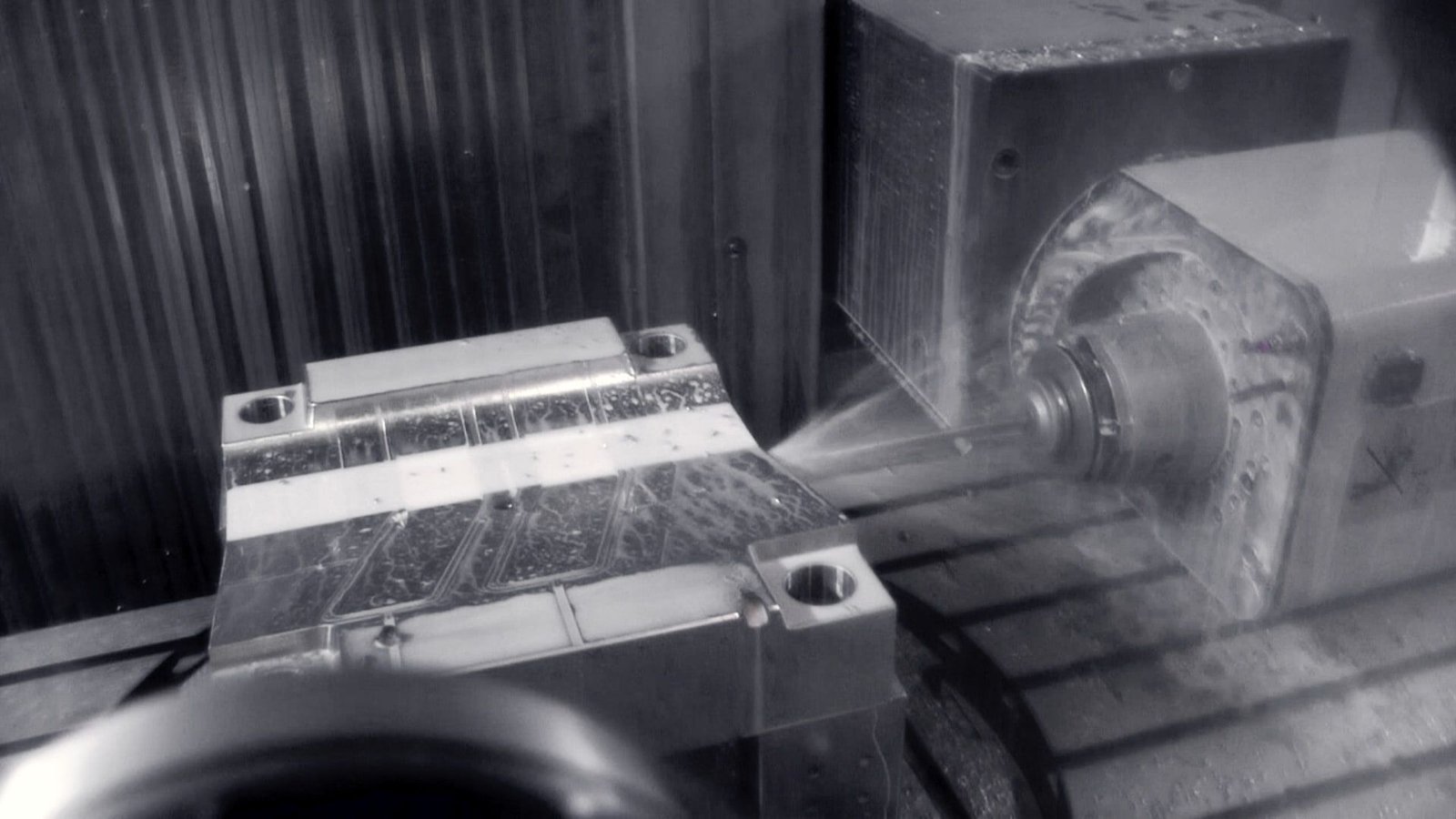 Industrialisation: milling the cavity of an injection mould, coolant spraying over the steel